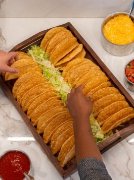 Taco Bar Catering from Red Mesa- Hands reaching for tortilla shells.