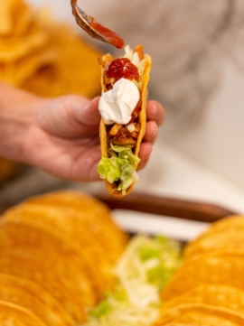 Topping a Taco with Salsa- Taco Bar Catering from Red Mesa